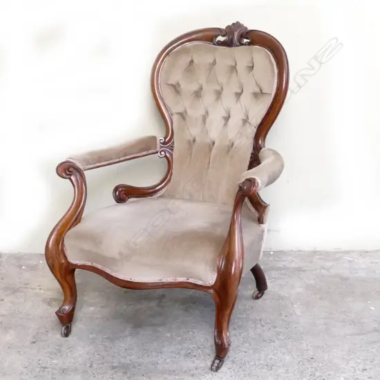 A Victorian walnut open elbow armchair