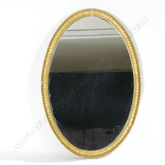 An oval giltwood framed mirror