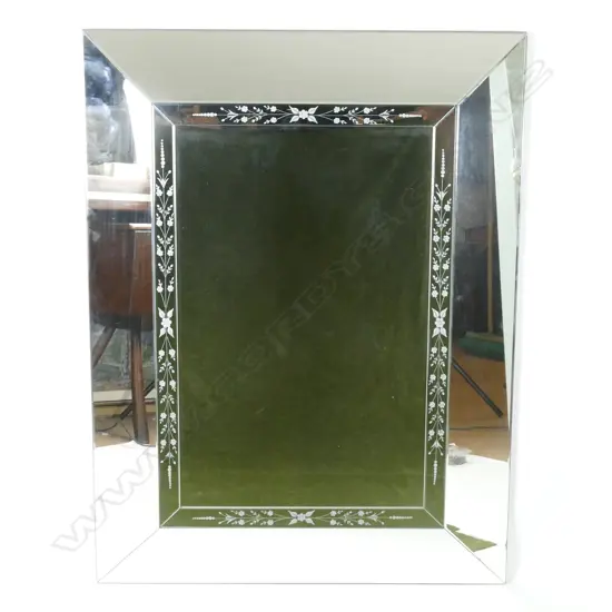 A large contemporary bevelled framed mirror