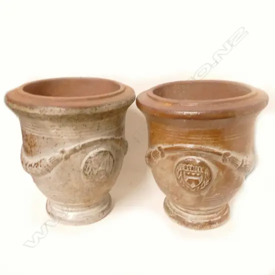 A pair of French antique style pottery garden urns