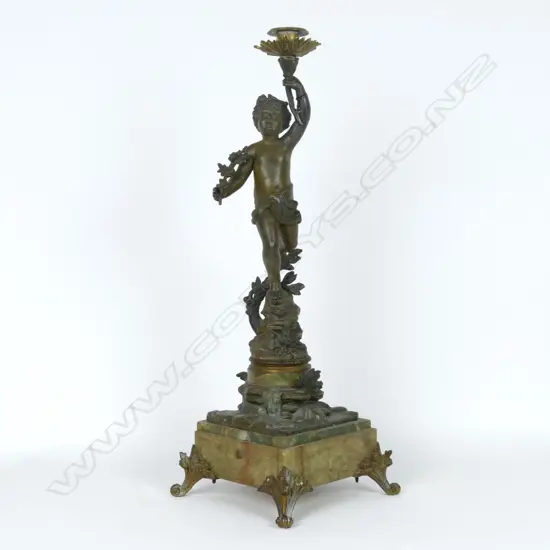 A spelter bronzed figural candlestick