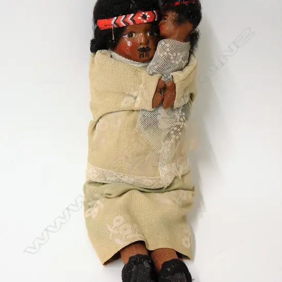 A vintage composite and cloth bodied Maori mother and child doll