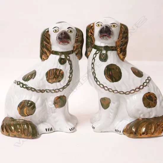 A pair of Victorian Staffordshire seated mantel dogs