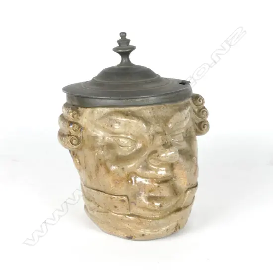 A stoneware pot modelled as the head of a wigged lawyer