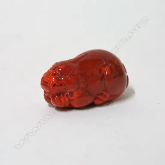 A Chinese red agate carved mythical animal