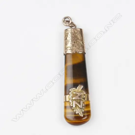 A colonial 9ct. rose gold and tiger's pendant