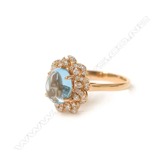 A modern 18ct. rose gold topaz and diamond cluster ring