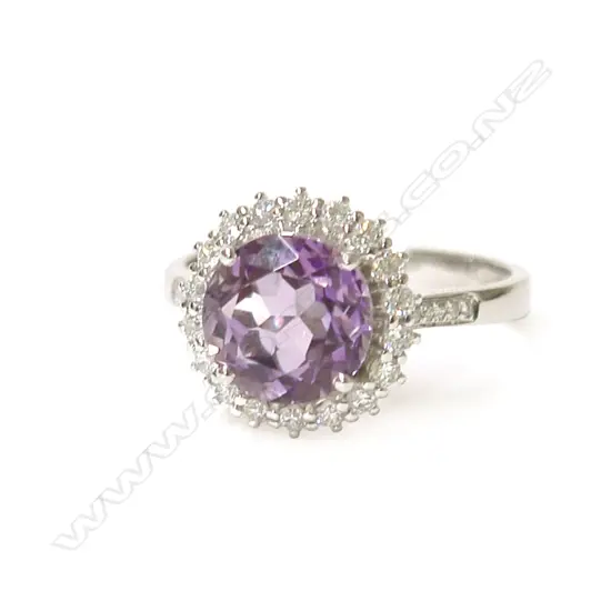 A modern 18ct. white gold amethyst and diamond cluster ring