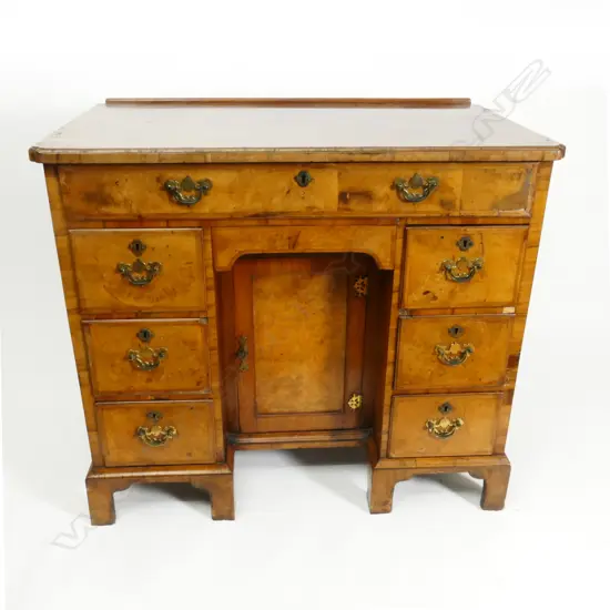 A 19thC Queen Anne style figured walnut lady's knee hole desk