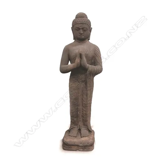 A large carved black stone standing Buddha