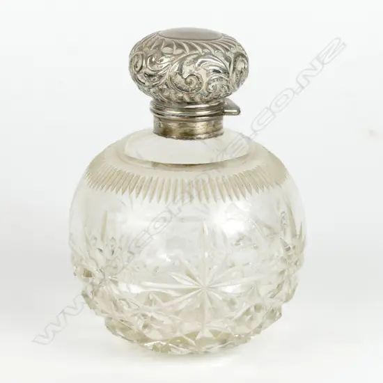 An Edwardian silver and crystal perfume bottle