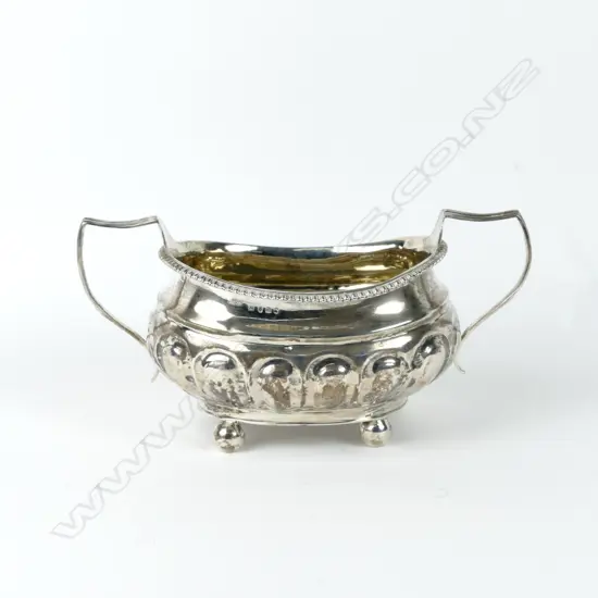A Georgian crested silver two-handled sugar basin