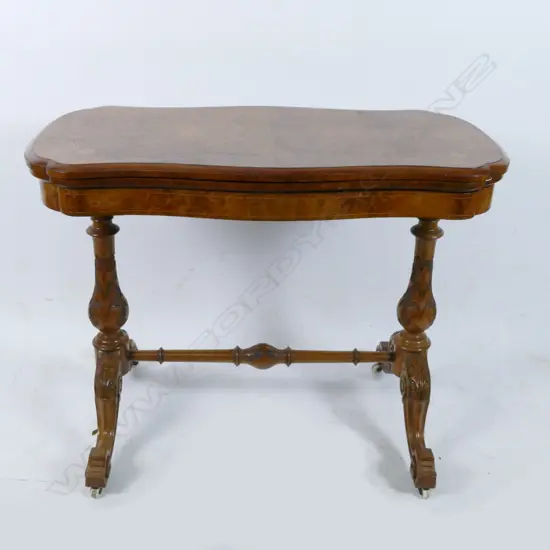 A Victorian walnut flap-top card table