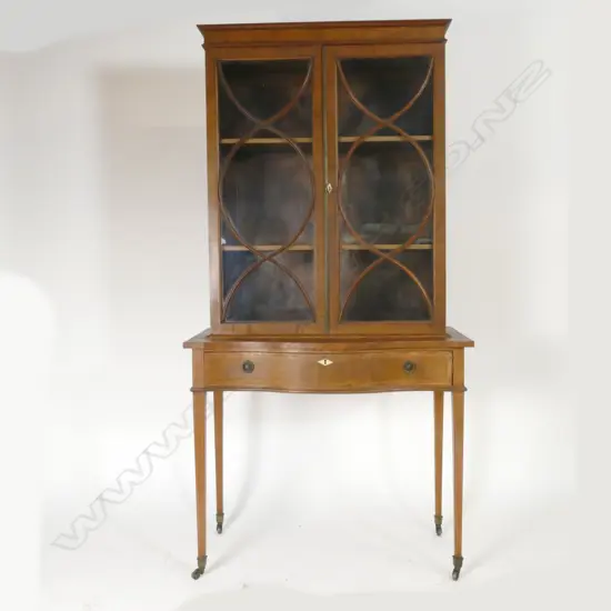 An Edwardian Sheraton Revival display vitrine on table base