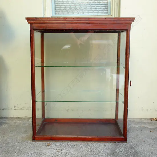 A colonial stained pine glazed shop counter cabinet
