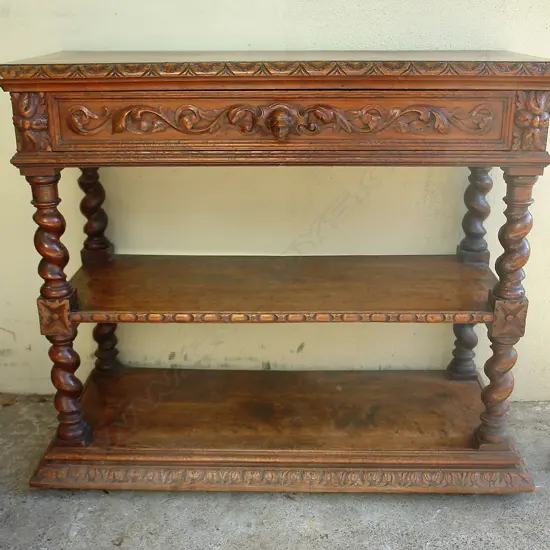 A 19thC carved oak dumb waiter