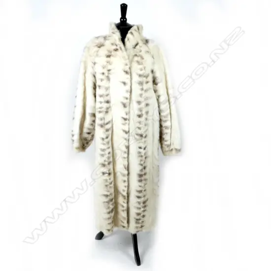 A below-the-knee white mink fur coat with brown mink detail in restrained pattern