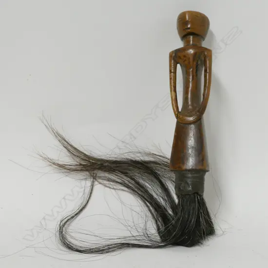 A carved Central African fly whisk