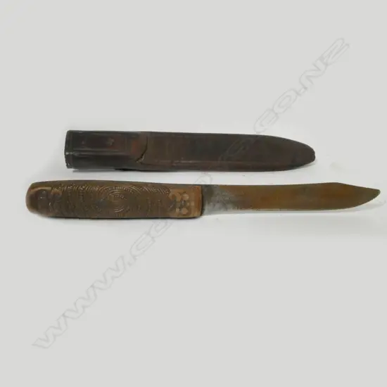 A sheath knife with Maori carved wooden handle