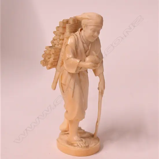 A Japanese Meiji period carved ivory okimono of a woodsman