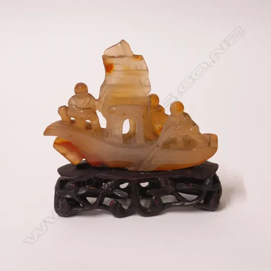 A 19thC Chinese carved agate sculpture of three figures on a boat