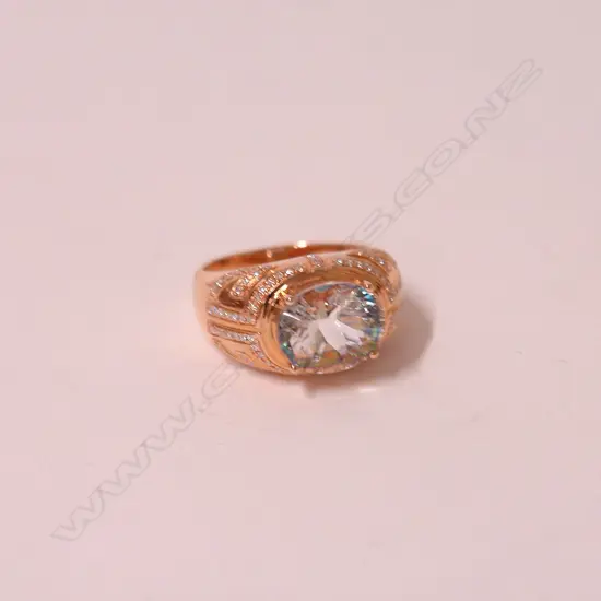 A lady's modern 18ct. rose gold aquamarine and diamond dress ring