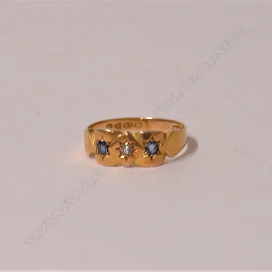An Edwardian 18ct. sapphire and diamond gypsy type ring
