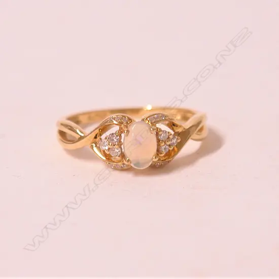 A lady's modern 18ct. yellow gold opal and diamond dress ring