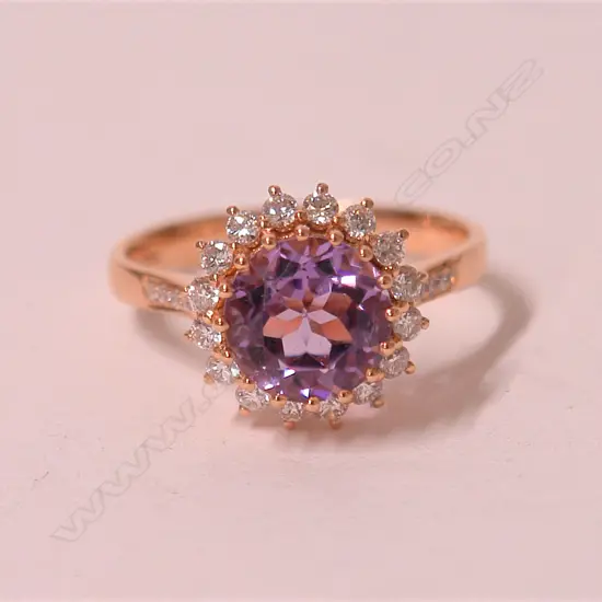A lady's modern 18ct. rose gold amethyst and diamond dress ring