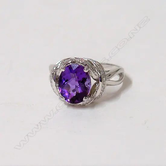 A modern 18ct. white gold amethyst and diamond dress ring