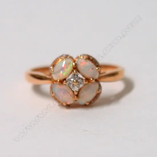 A lady's modern 18ct. rose gold opal and diamond ring