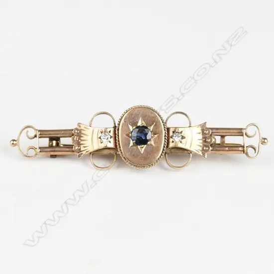 An Edwardian 9ct. rose gold diamond and sapphire bar brooch