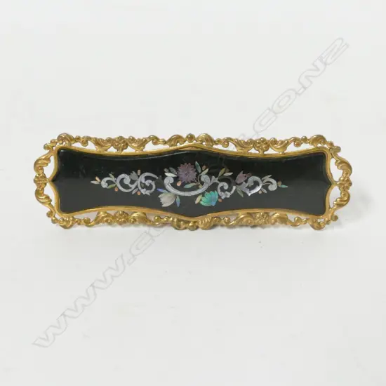 A Victorian gilt metal and inlaid brooch