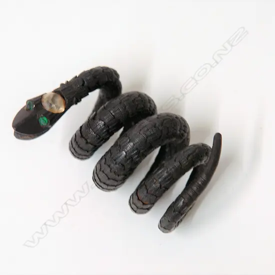 A 19thC sectional carved ebony articulated snake bangle