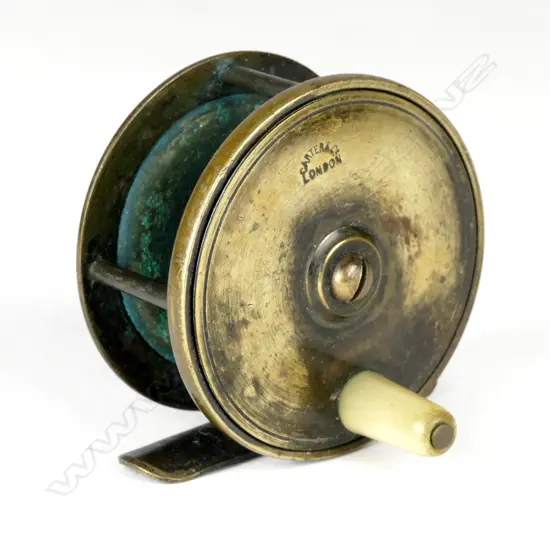 A brass 2½" x 1½" plate fishing reel