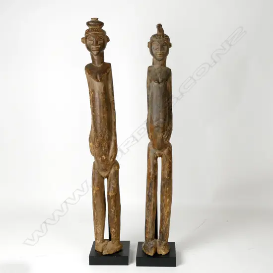 A pair of tall African cast wooden female figures