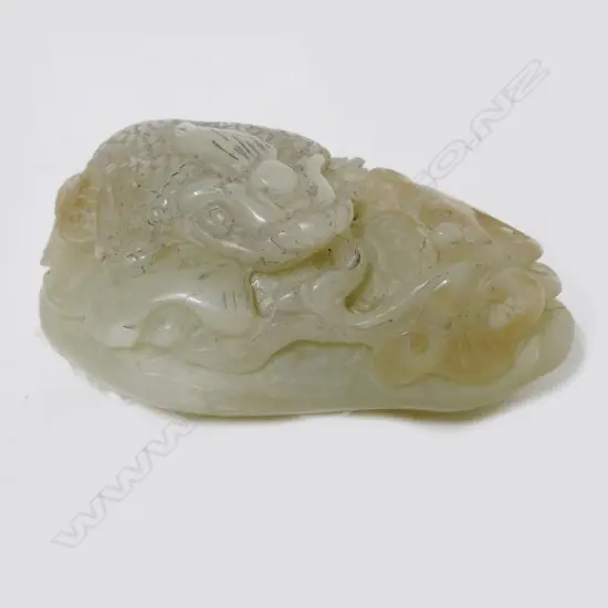 A Chinese pale jade handling piece