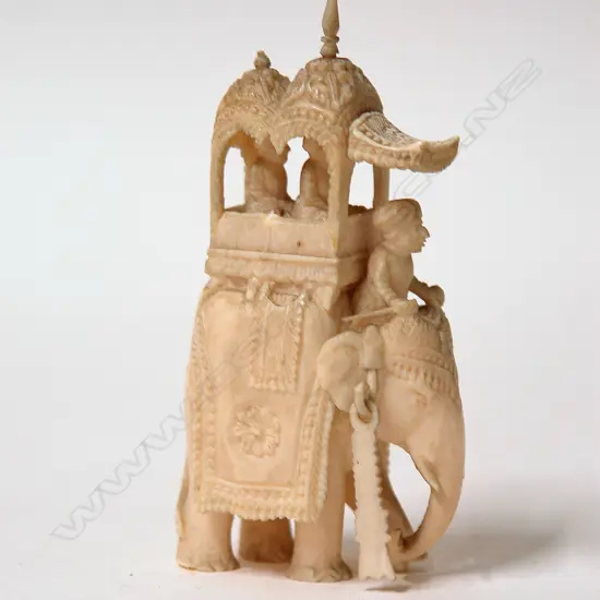 A vintage Indian finely carved ivory elephant with howdah