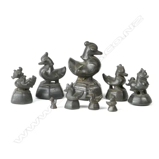 A set of nine antique graduated Burmese bronze bird opium weights