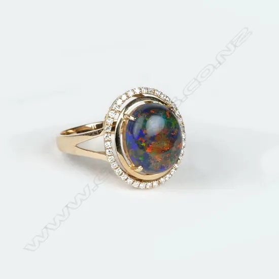 An 18ct. rose gold opal and diamond dress ring