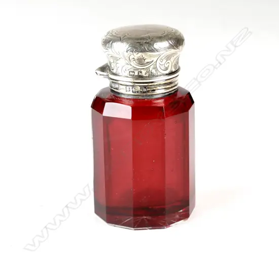 An Edwardian ruby glass and silver top smelling salt bottle
