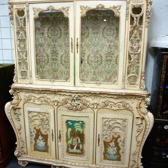 A mid-20thC highly ornate French-style rococo-style painted and gilded cabinet