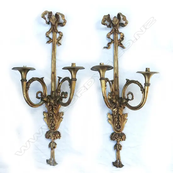 A pair of cast brass trumpet twin light wall brackets of French Louis XV style