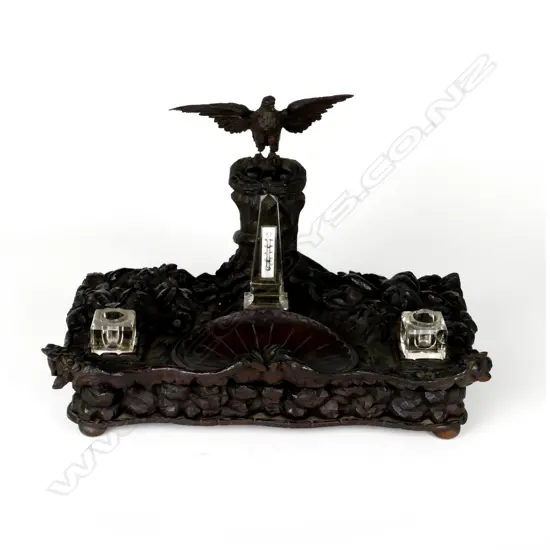 An early 19thC European desk stand of carved mahogany