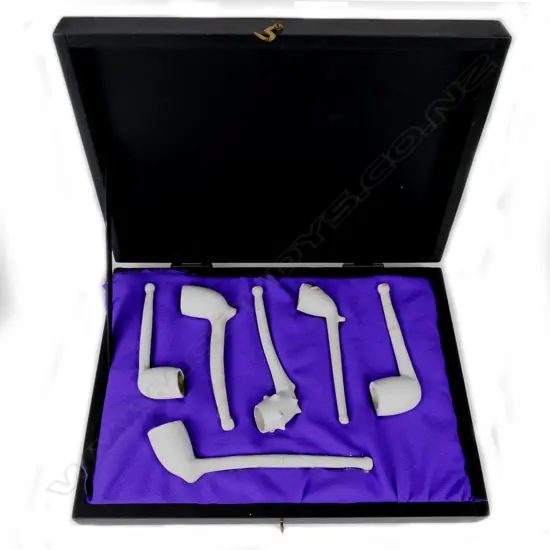 A cased collection of clay pipes