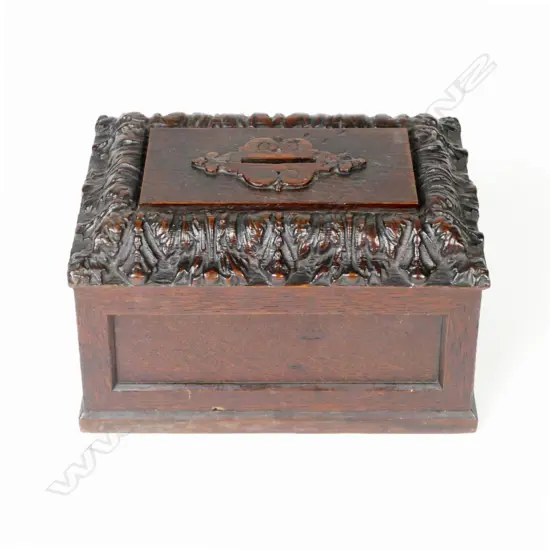 A vintage carved oak donation box
