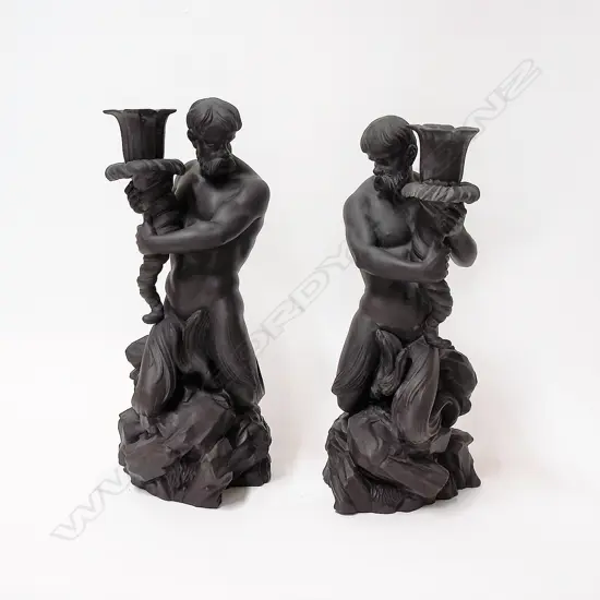 A pair of 20thC finely modelled Wedgwood black basalt mermen/Neptune candlesticks