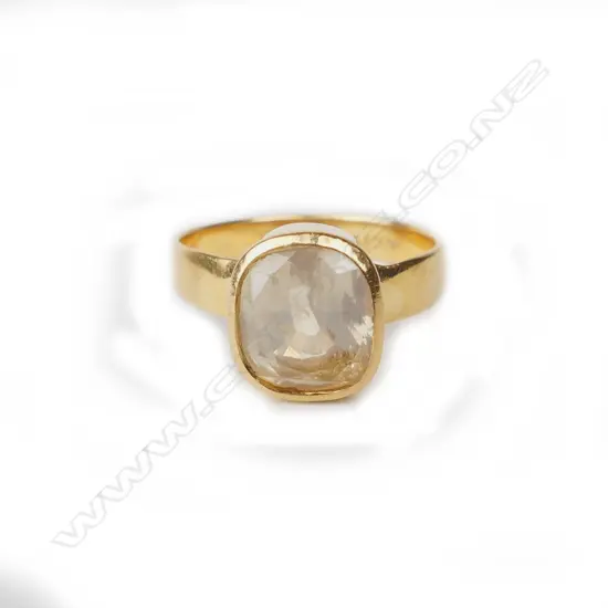 An estate 22ct. yellow gold and yellow sapphire ring