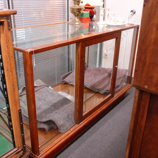 A vintage mahogany shop display cabinet