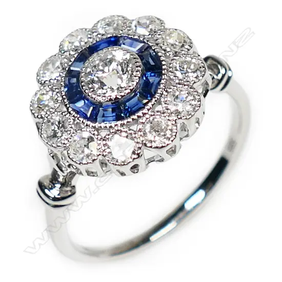A 14ct white gold, sapphire and diamond halo ring,